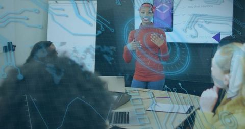 Midcareer woman leading tech presentation with hud overlay in modern boardroom