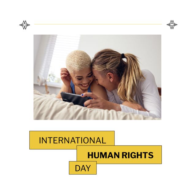 Multiracial lesbian couple with cellphone lying on bed and international human rights day text. Composite, love, together, homosexual, technology, happy, equality, freedom, support and celebration.