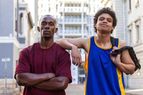 Street basketball teammates posing confidently on urban city street