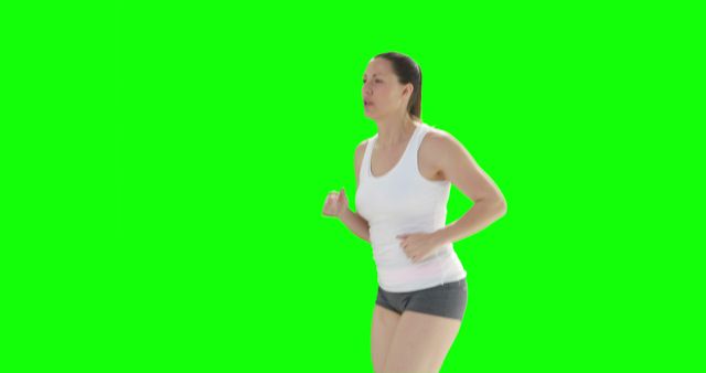 This image shows a woman power walking in athletic attire against a green screen background. Ideal for fitness and health marketing materials, exercise tutorials, or promoting active lifestyles.