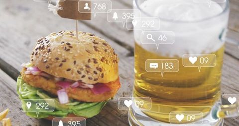Gourmet Burger and Beer with Social Media Icons on Rustic Table