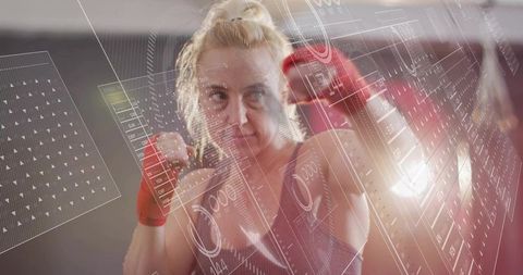 Female boxer training with futuristic hud overlays showing performance data focus and power