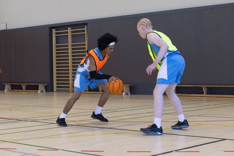 Intense basketball training session on indoor court
