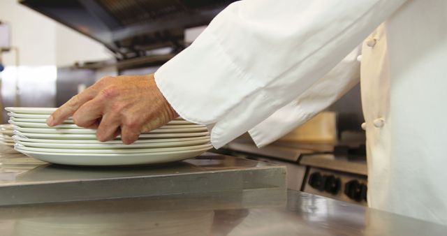 Chef Stacking White Plates in Commercial Kitchen - Download Free Stock Images Pikwizard.com