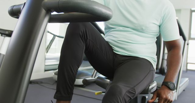 Fitness Enthusiast Exercising on Stationary Bike in Modern Gym - Download Free Stock Images Pikwizard.com