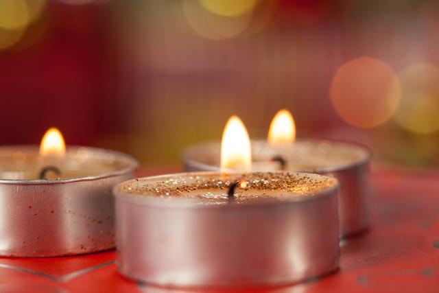 Close-up of candles burning during christmas time