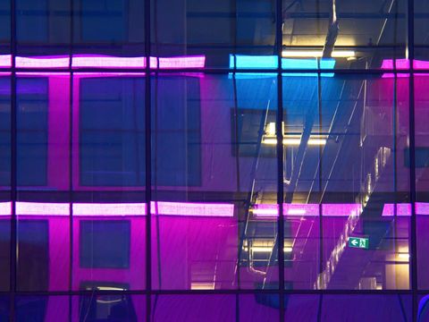 Colorful reflections on modern building glass design at night