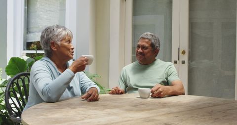 Senior Couple Enjoying Coffee on Sunny Patio - Download Free Stock Images Pikwizard.com