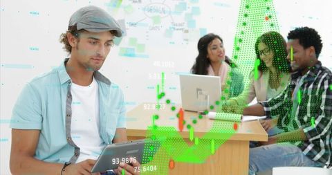 Man Analyzing Data on Tablet in Modern Collaborative Office Environment