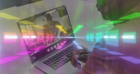 Senior professional collaborating on laptop with neon data overlays and taking notes