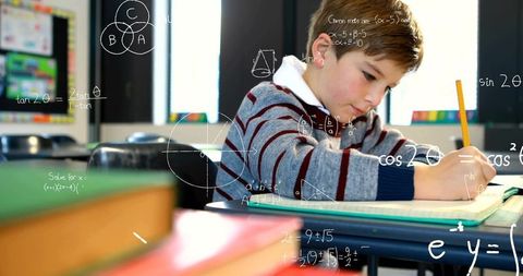 Focused student writing equations in classroom setting