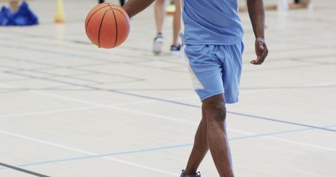 African American Male Basketball Player Dribbling on Indoor Court
