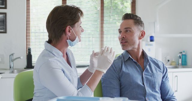 Dentist and Patient During Consultation in Dental Clinic - Download Free Stock Images Pikwizard.com