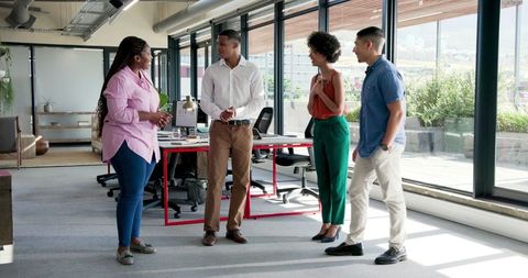 Diverse Team Sharing Ideas in Modern Office Space