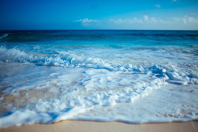 Waves Crashing on Sandy Beach with Clear Blue Sky - Download Free Stock Photos Pikwizard.com