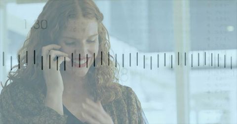 Businesswoman Engaging in Call Amid Modern Office Ambience with Graph Overlay