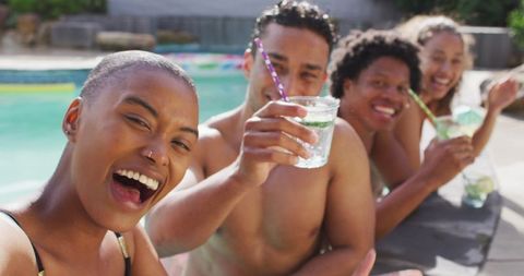 Diverse Friends Celebrating at Pool Party with Drinks