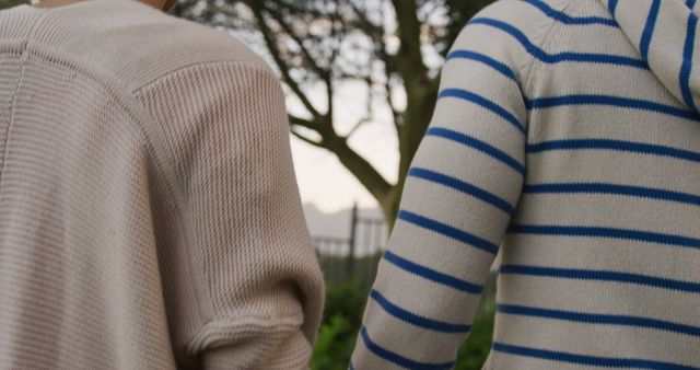 Rear midsection of caucasian couple walking holding hands in garden - Download Free Stock Photos Pikwizard.com