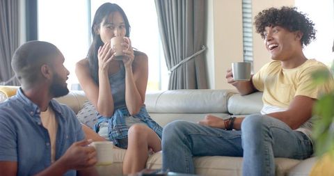 Diverse Friends Enjoy Relaxing Coffee Break in Cozy Living Room