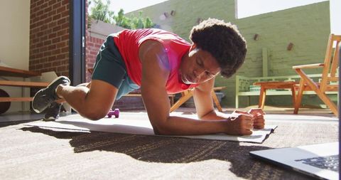 African American Man Exercises at Home with Push-Ups for Healthy Lifestyle