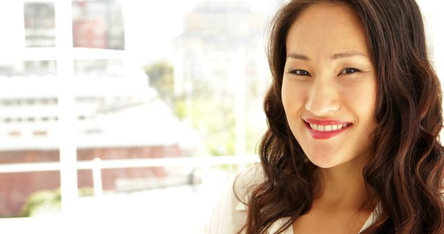 Smiling Professional Woman With Long Hair in Office Environment - Download Free Stock Images Pikwizard.com