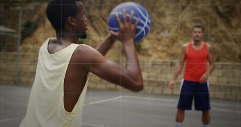 Basketball Practice on Outdoor Court with Natural Stone Backdrop
