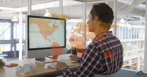 Data Analyst Working in Open Plan Office with World Map Overlay