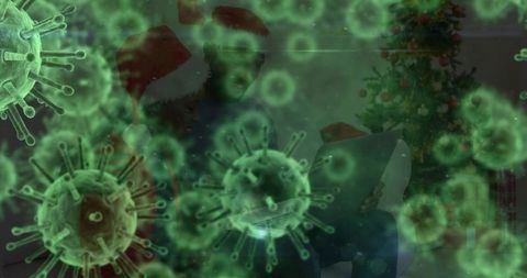 Family watching laptop on couch wearing Santa hats with green virus overlay and Christmas tree