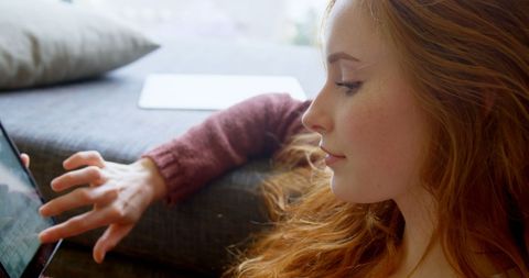 Woman Browsing on Tablet Highlighting Tech in Home Lifestyle