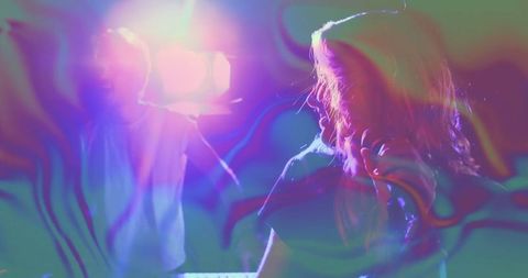 Female Singer Performing on Stage with Vibrant Lighting