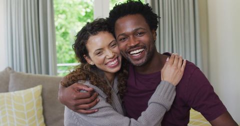 Happy Couple Embracing and Smiling in Living Room - Download Free Stock Images Pikwizard.com
