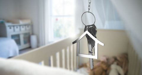 House Key Hanging in Cozy Bedroom Representing Home Ownership