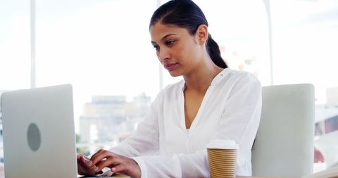 Young Professional Woman Working at Laptop in Bright Office Setting - Download Free Stock Images Pikwizard.com
