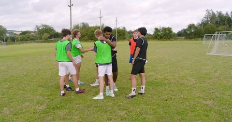 Teenage Boys Showing Team Camaraderie on Outdoor Sports Field
