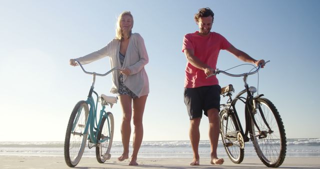 Happy Couple Walking Bikes Along Beach at Sunset - Download Free Stock Images Pikwizard.com