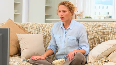 Stressed Woman Watching Television with Intense Expression