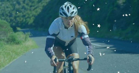 Female Cyclist Determinedly Riding on Scenic Hillside Road