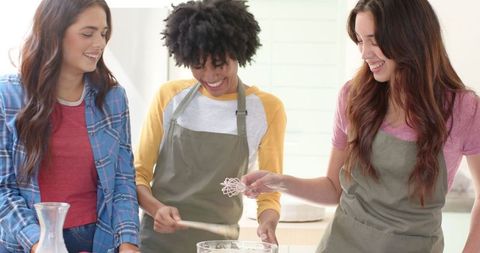 Diverse Friends Baking Together in Kitchen with Laughter and Joy