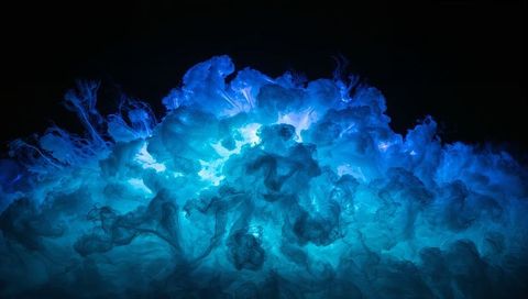 Luminous Blue Ink Plume Rising with Turbulent Teal Glow and Filaments