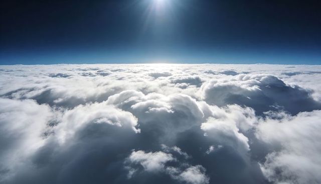Sunlit high-altitude cumulus cloudscape stretching to horizon from aerial perspective