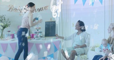 Smiling expectant mother holding belly at pastel home baby shower with cupcake tower, gifts