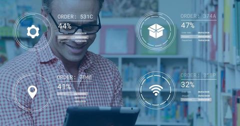 Man Analyzing Digital Orders on Tablet in Modern Library
