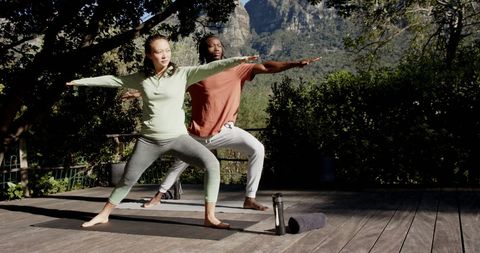 Diverse Couple Practicing Yoga Outdoors in Tranquil Garden