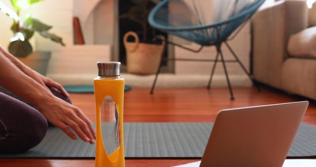 Practicing Yoga at Home with Water Bottle and Laptop - Download Free Stock Images Pikwizard.com