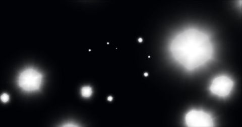 Abstract glowing white spots in dynamic motion