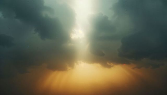 Dramatic Sky with Sunlight Rays Dispelling Dark Clouds