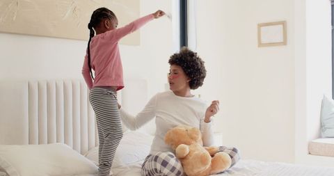 Mother and Daughter Sharing Playful Moment on Bright Morning