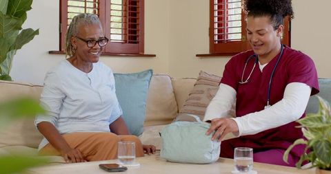 Home healthcare professional with senior unpacking medical kit