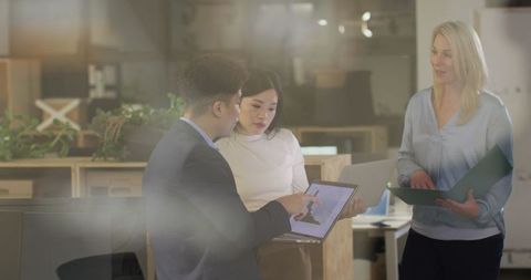 Diverse team collaboration on project in modern office