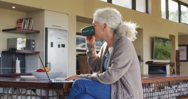 Senior Woman Drinking Coffee While Working on Laptop at Home - Download Free Stock Images Pikwizard.com